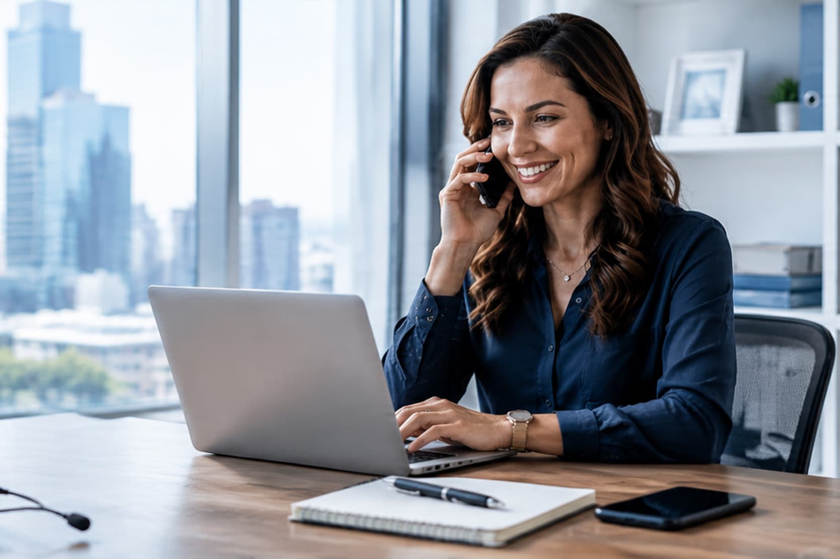 Majoka Accounting professional on a call at a laptop with a city skyline behind